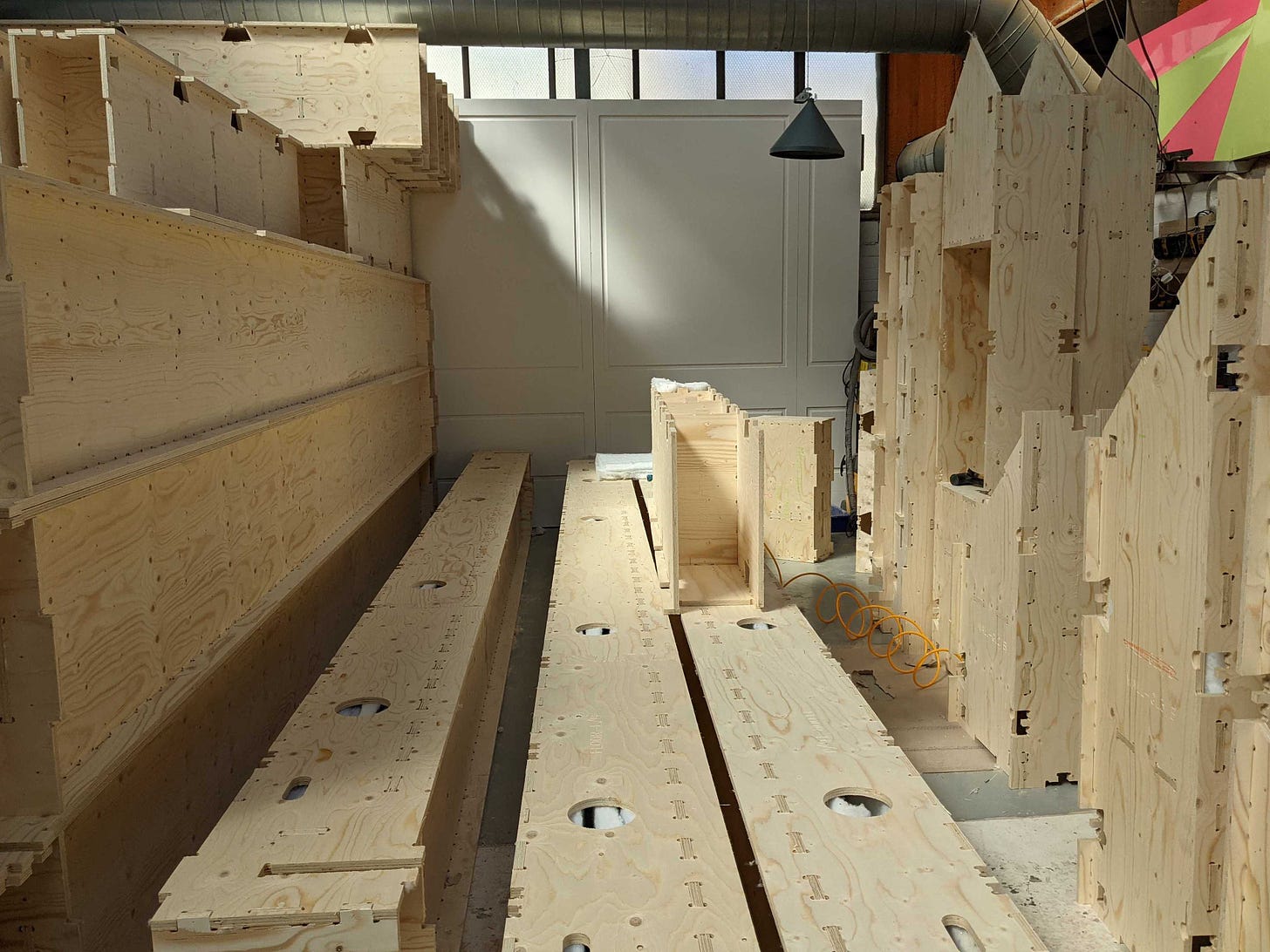 Various sizes of WikiHouse Skylark blocks are shown in a warehouse space