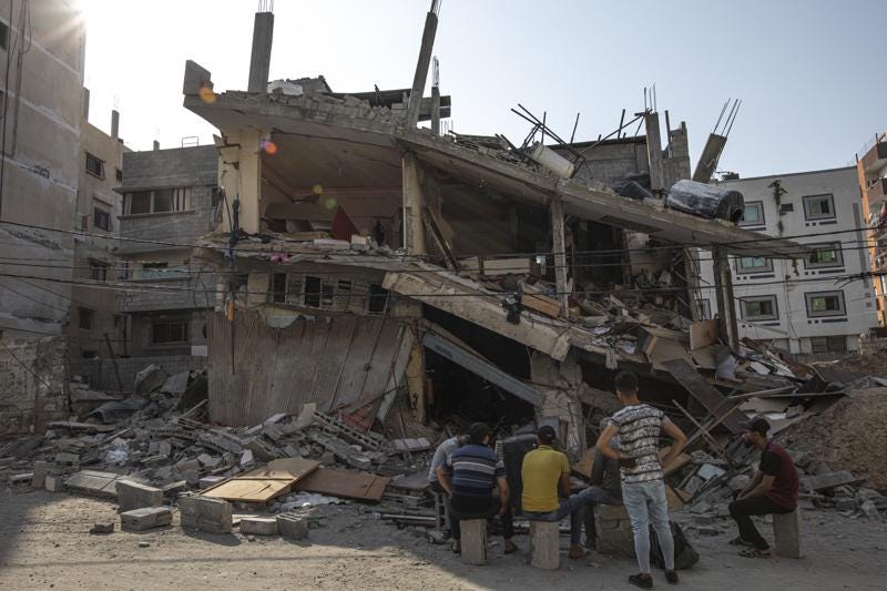 Palestinians inspect their house which was hit by an Israeli airstrike in Gaza City, Monday, Aug. 8, 2022. A cease-fire between Israel and Palestinian militants has taken effect late Sunday in a bid to end nearly three days of violence that has killed dozens of Palestinians. (AP Photo/Fatima Shbair)