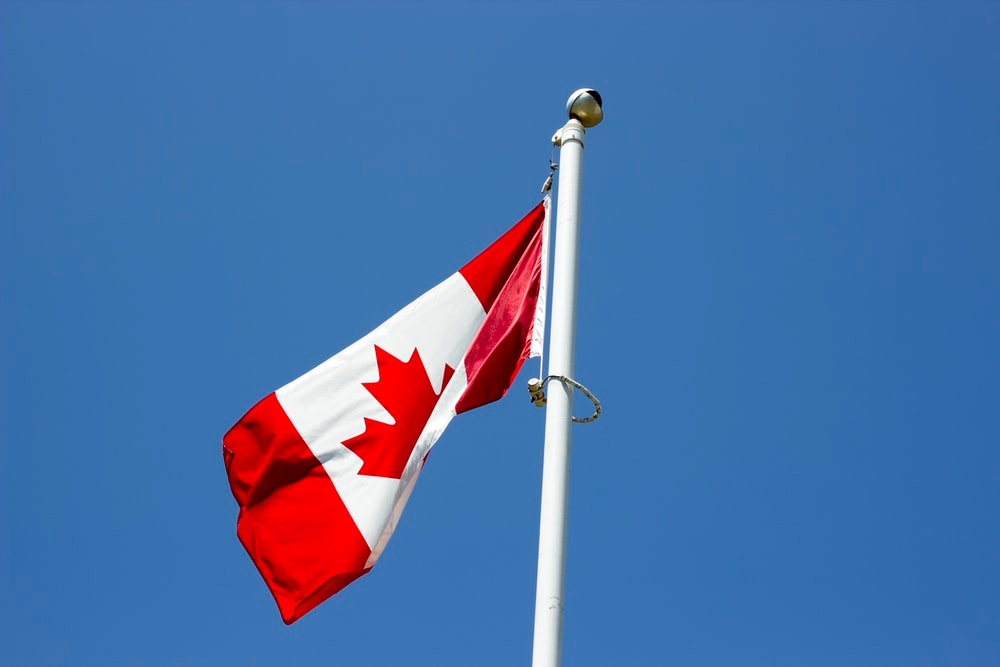 flag of Canada under blue sky at daytime