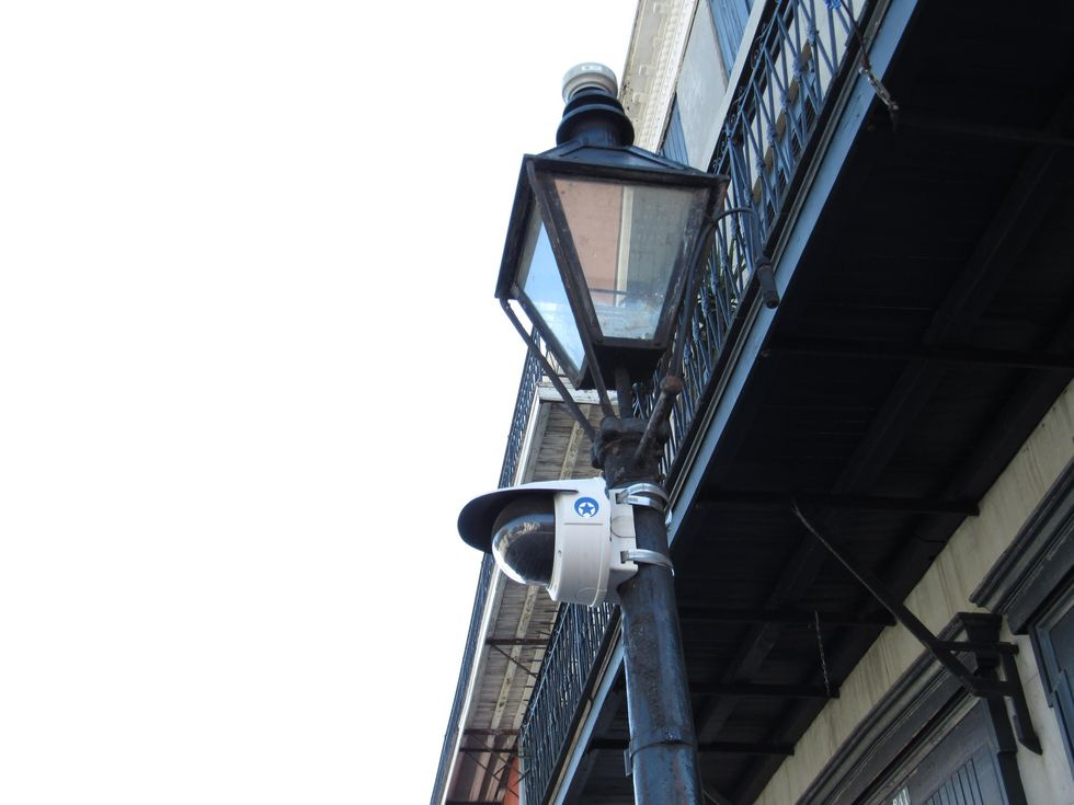 A surveillance camera on a lightpost.