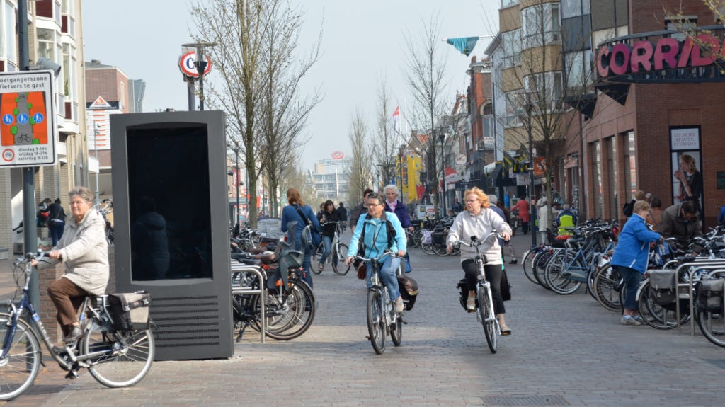 dutch people cycling on a street with great infrastructure