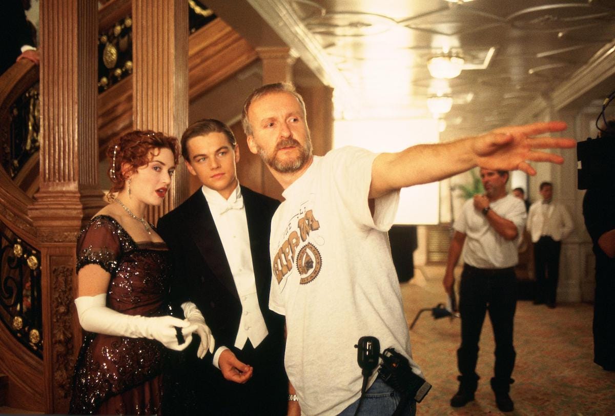 James Cameron on set with actors filming Titanic.