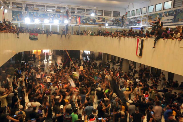 Iraqi protesters storm parliament in Baghdad, set up sit-in | TribLIVE.com
