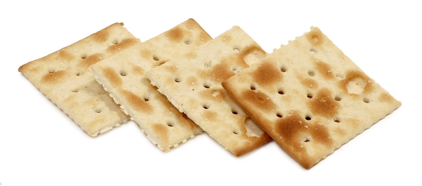 Four saltines splayed out like poker cards.