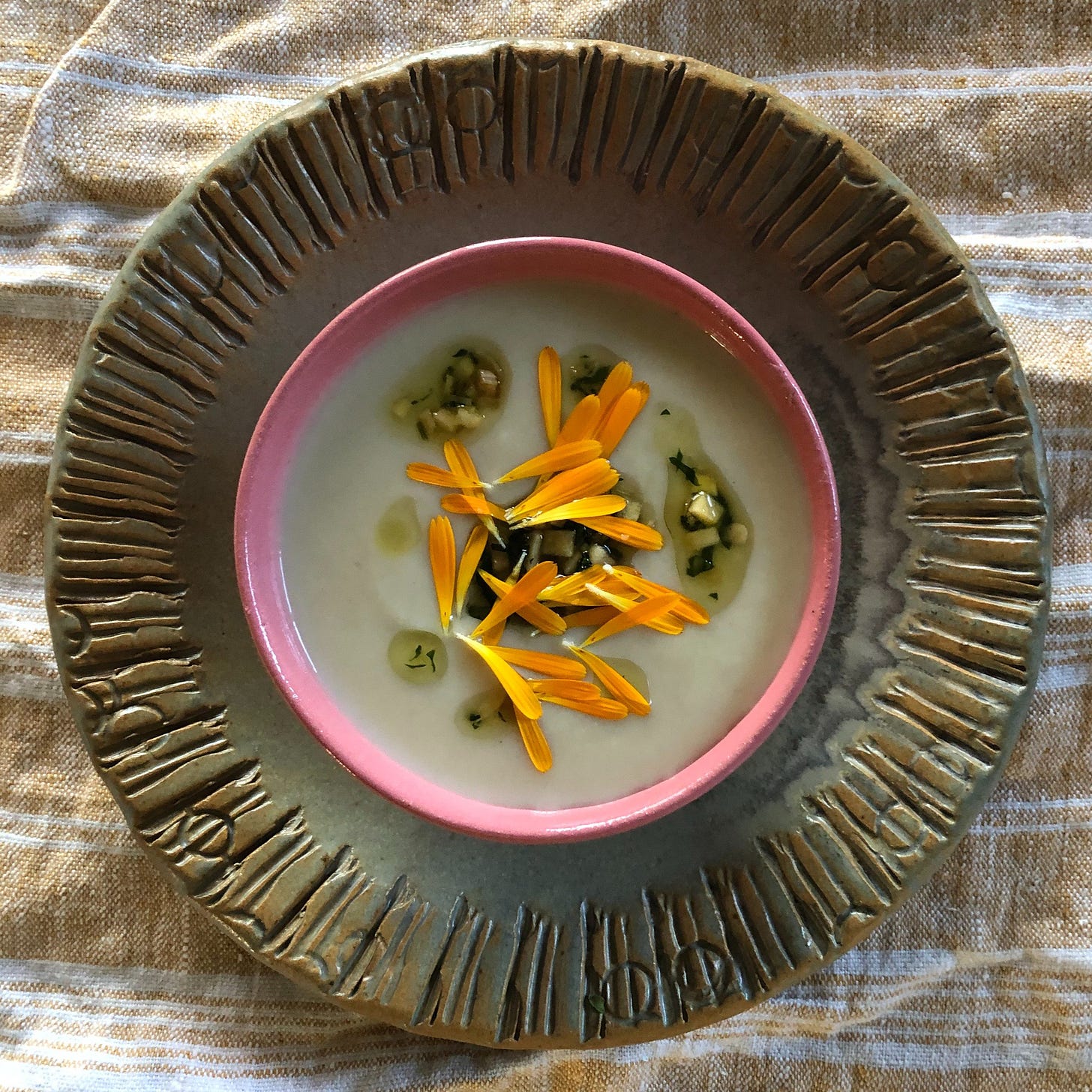 Sunchoke soup garnished with marigold petals 