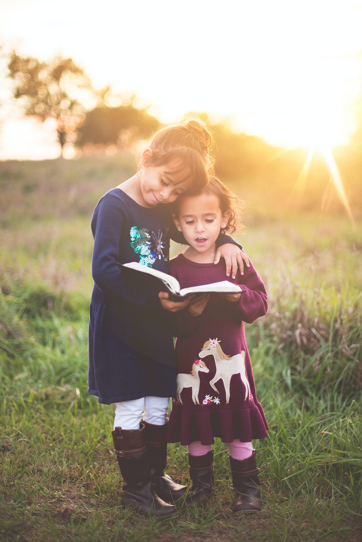 Two girls reading the Bible.