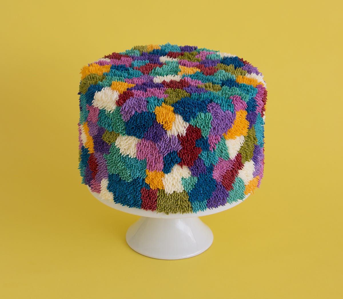 Cake frosted to resemble multi-colored patches of shag carpet.