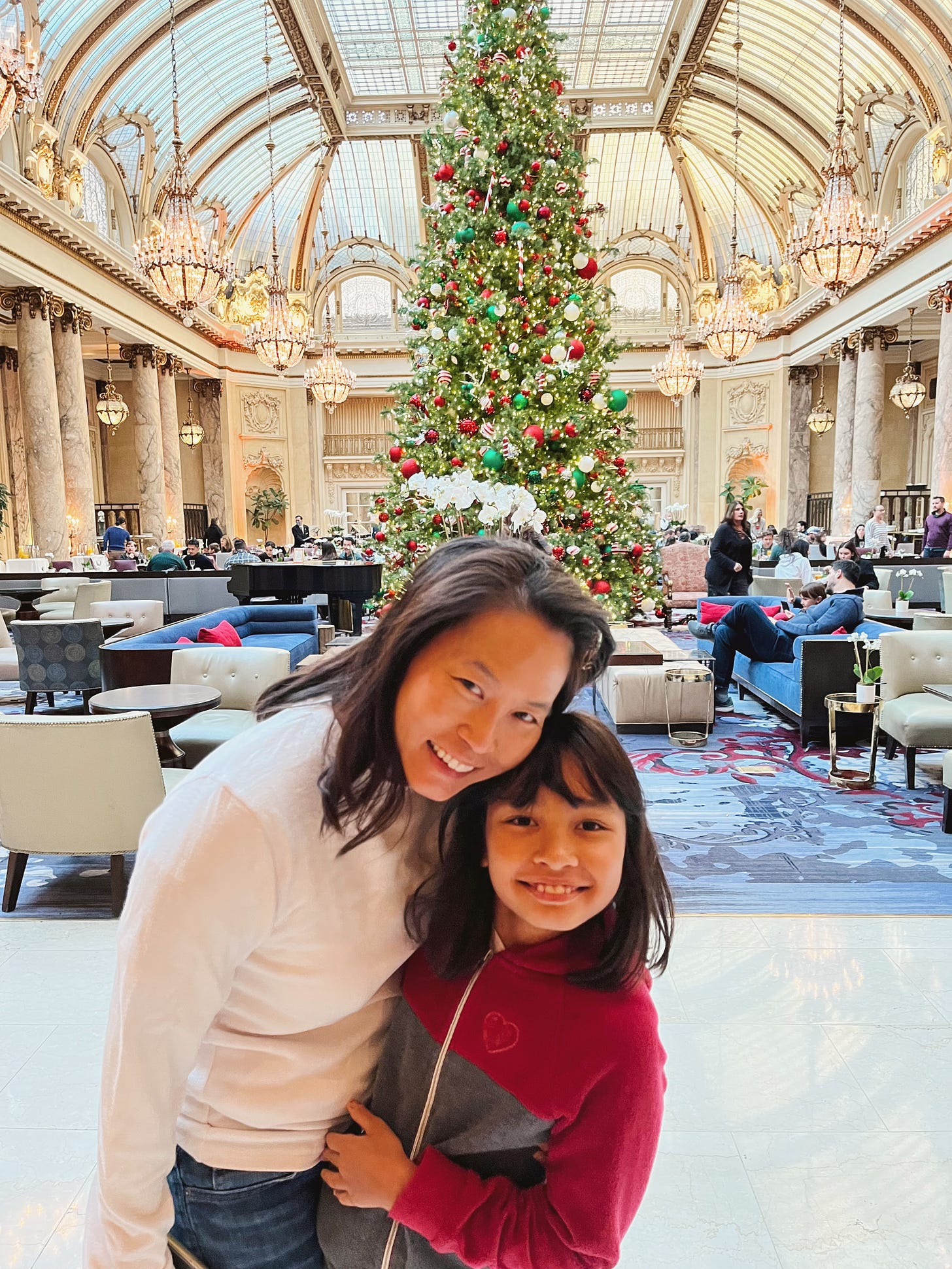 woman and girl in front of lobby Christmas tree at Palace Hotel
