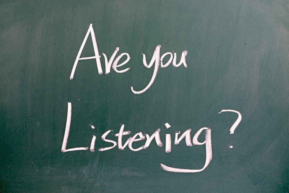"Are you listening" written on blackboard