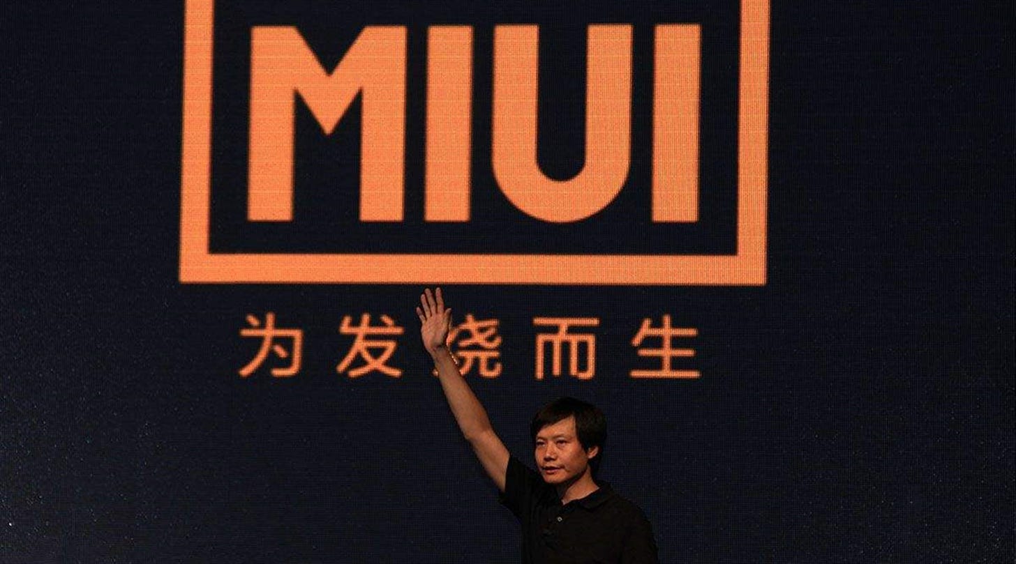 Xiaomi’s CEO, Lei Jun, in front of Xiaomi’s Slogan (Image: Sina)