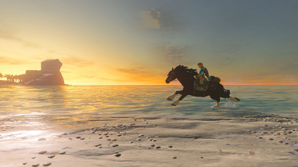 A young man in a blue shirt rides a horse across a beach at sunset. A small rocky island surrounded by palm trees sits in the distance.