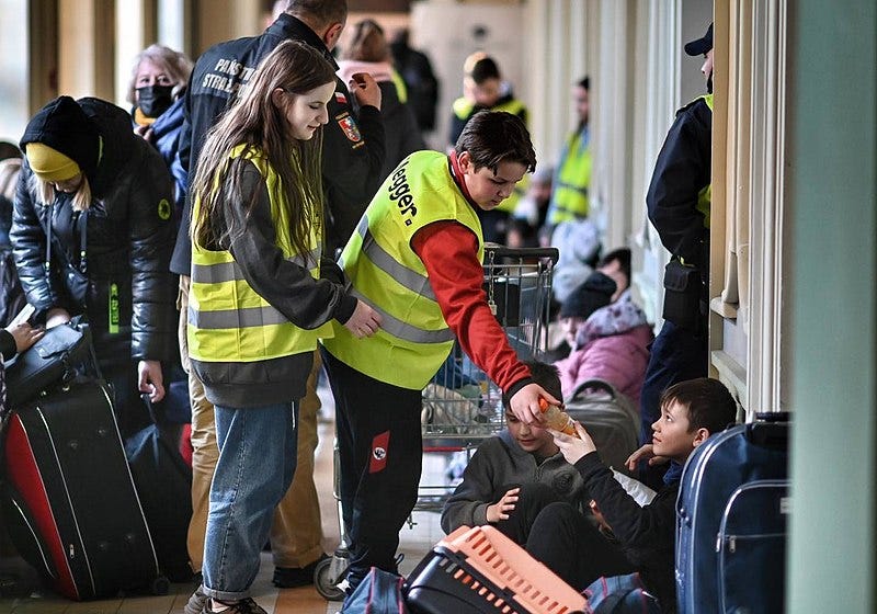 Volunteer helping refugee in Przemyśl Główny train station