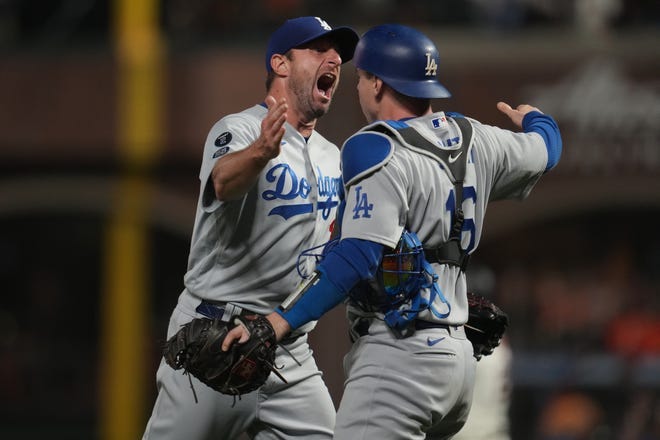 Dodgers' Max Scherzer and catcher Will Smith celebrate after the final out of Game 5 to beat the Giants.