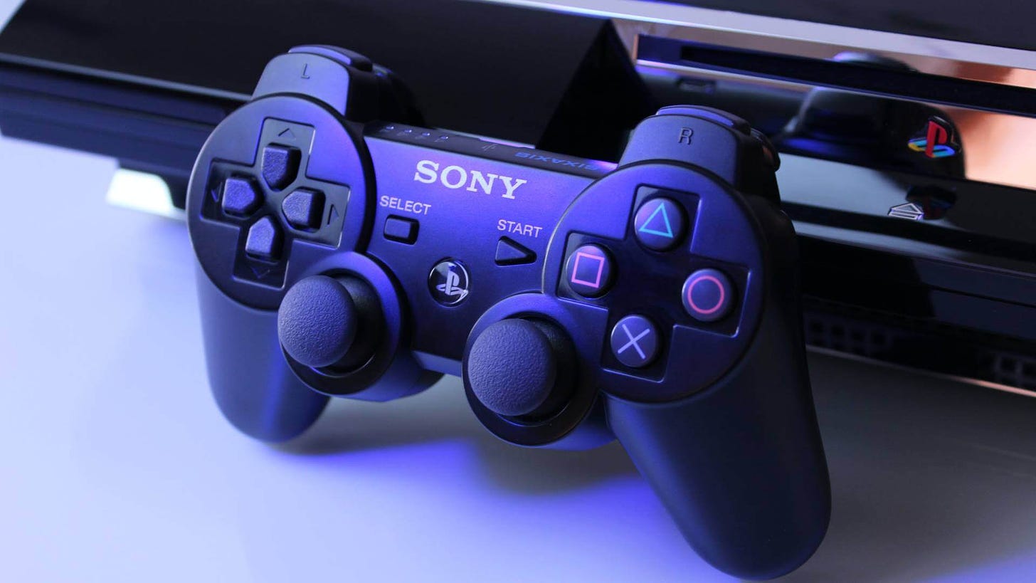PS3 DualShock controller resting against a PS3 console