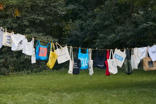 A laundry line of cotton totes accumulated by a single person since the race to replace plastic began.