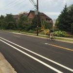 Bike lane in front of Francis Cabrini is striped eastbound, not westbound. A confident bicyclist takes the road anyway.