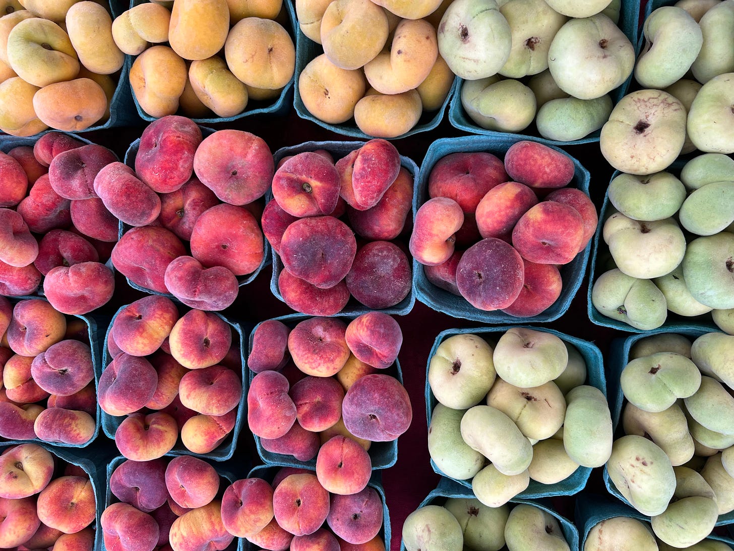 Flat peaches in yellow, orange, and light green