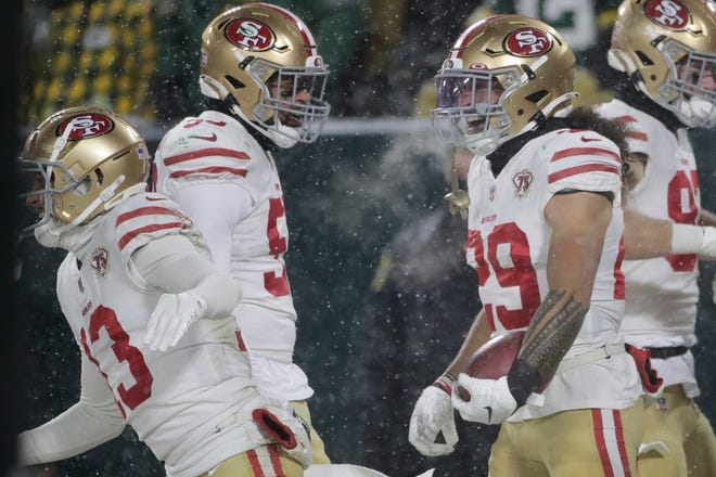 San Francisco 49ers' Talanoa Hufanga reacts after running a blocked punt in for a touchdown during the second half of an NFC divisional playoff NFL football game against the Green Bay Packers Saturday, Jan. 22, 2022, in Green Bay, Wis.