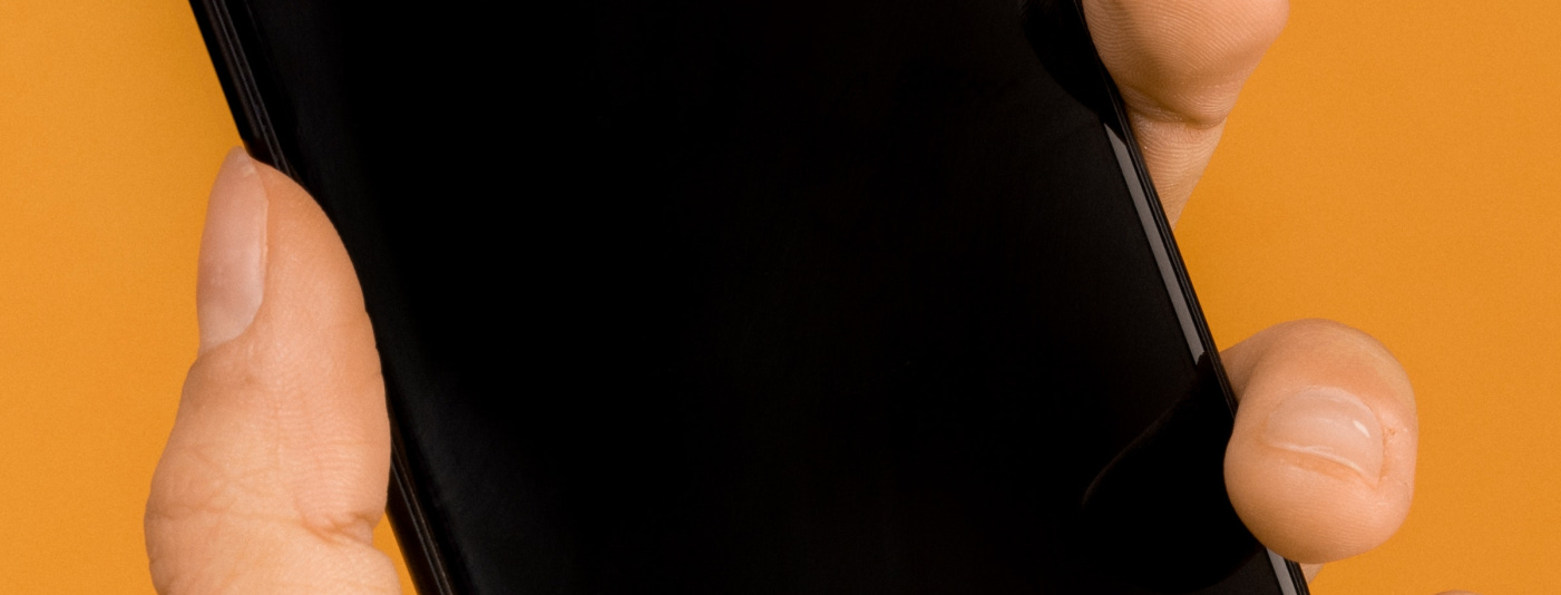 Someone holding a phone on their hand