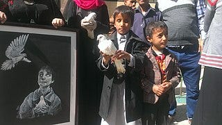 File:A blind child carries a dove at a protest against the attack on the al-Nour Center for the Blind in Sanaa - Yemen - 10-Jan-2016.jpg