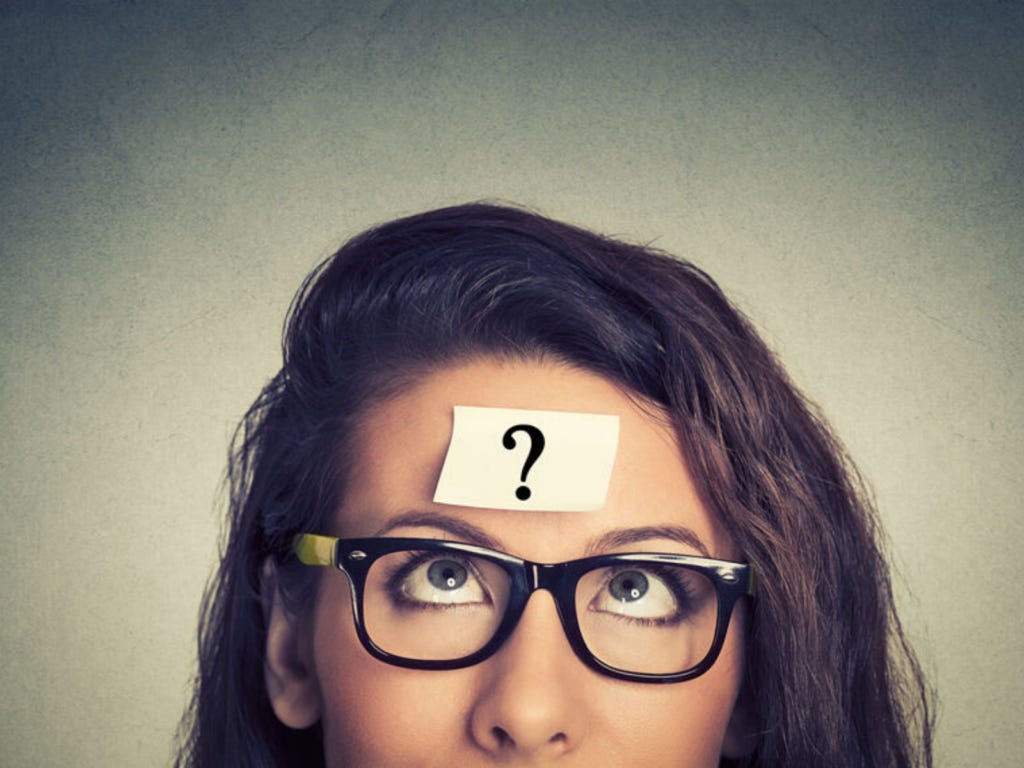 woman in glasses with question mark