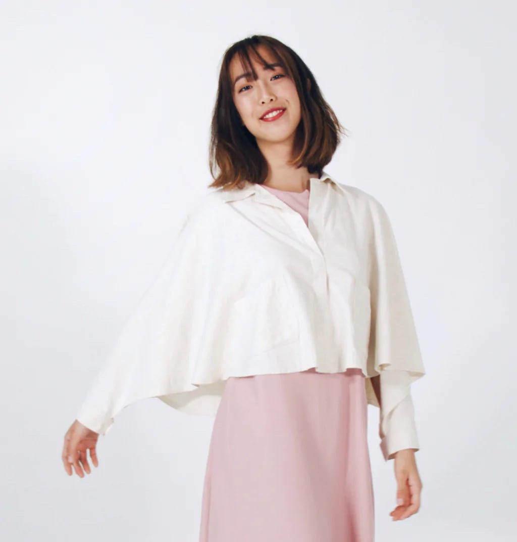 White cropped cape with magnetic cuff fasteners by Will & Well.