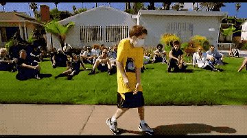 Gif of a boy in a yellow t-shirt and white cloth mask dancing real good, from the Alien Ant Farm “Smooth Criminal” video. 