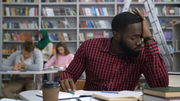 Tired Black Student Studying Difficult Assignment by stusya | VideoHive