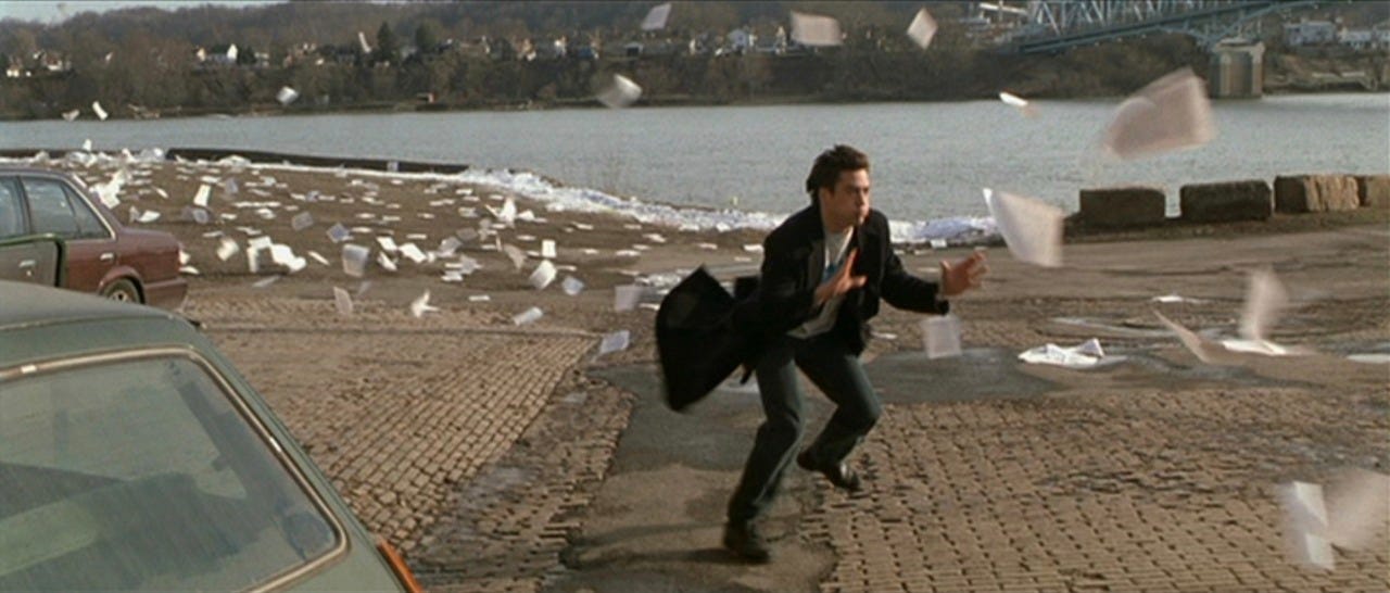 Robert Downey Jr. trying to catch manuscript pages flying away in Wonder Boys film.