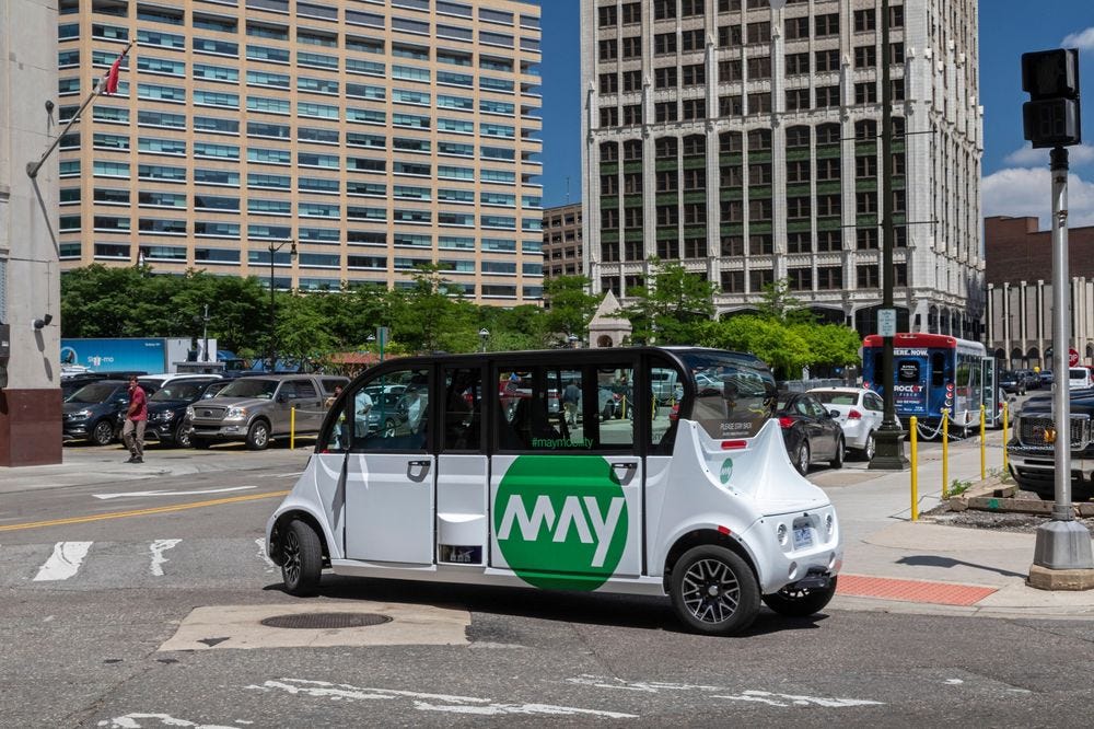 A self-driving shuttle from May Mobility transports commuters in downtown Detroit.