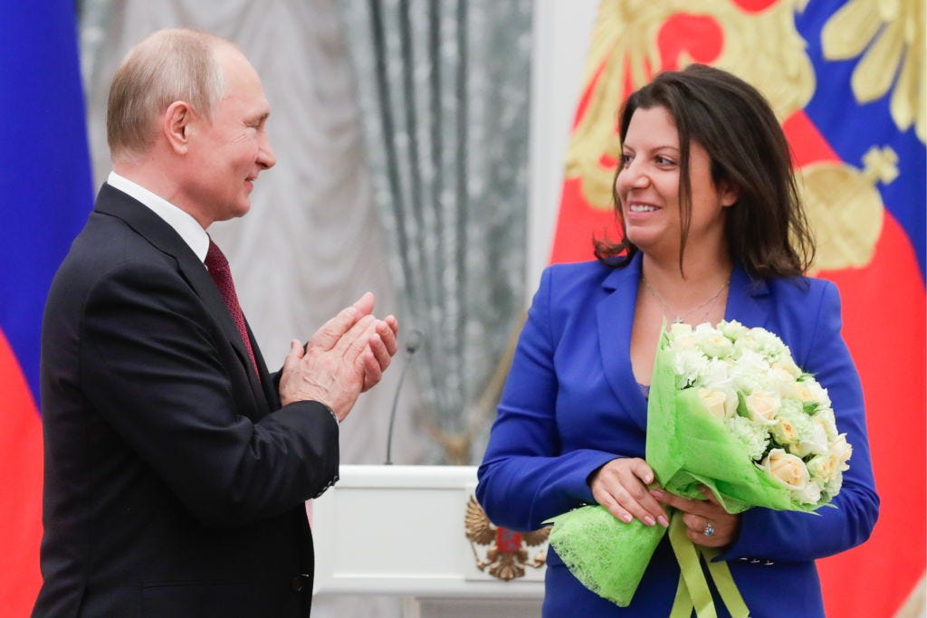 RT editor-in-chief Margarita Simonyan receives an award from Russian President Vladimir Putin at the Kremlin in 2019. (Mikhail Metzel / Getty Images) RT editor-in-chief Margarita Simonyan receives an award from Russian President Vladimir Putin at the Kremlin in 2019. (Mikhail Metzel / Getty Images)