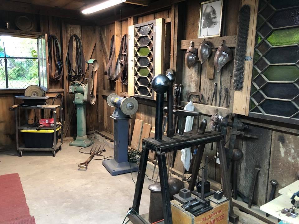 Armoury workshop showing both modern and medieval-style tools