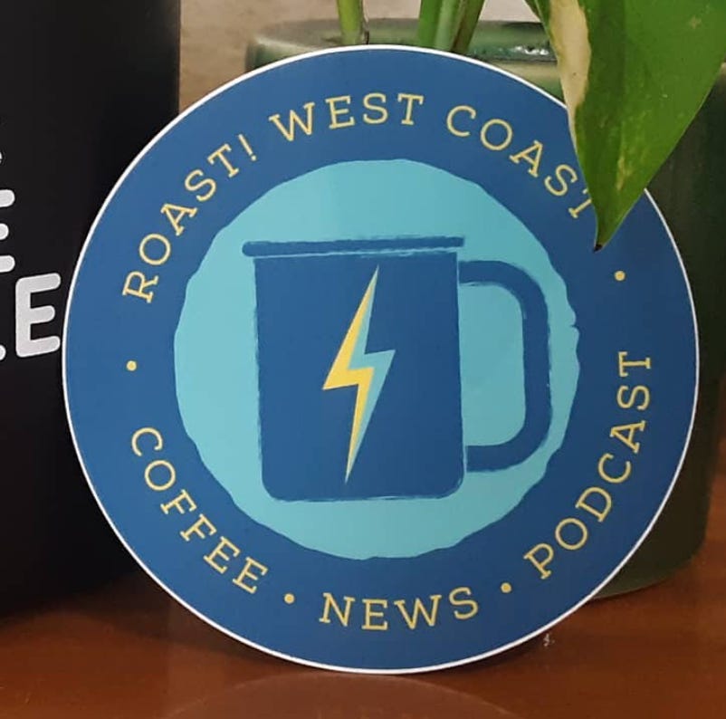 A blue and yellow Roast! West Coast Sticker with the name and in the middle a coffee mug illustration with a lightning bolt on the side.