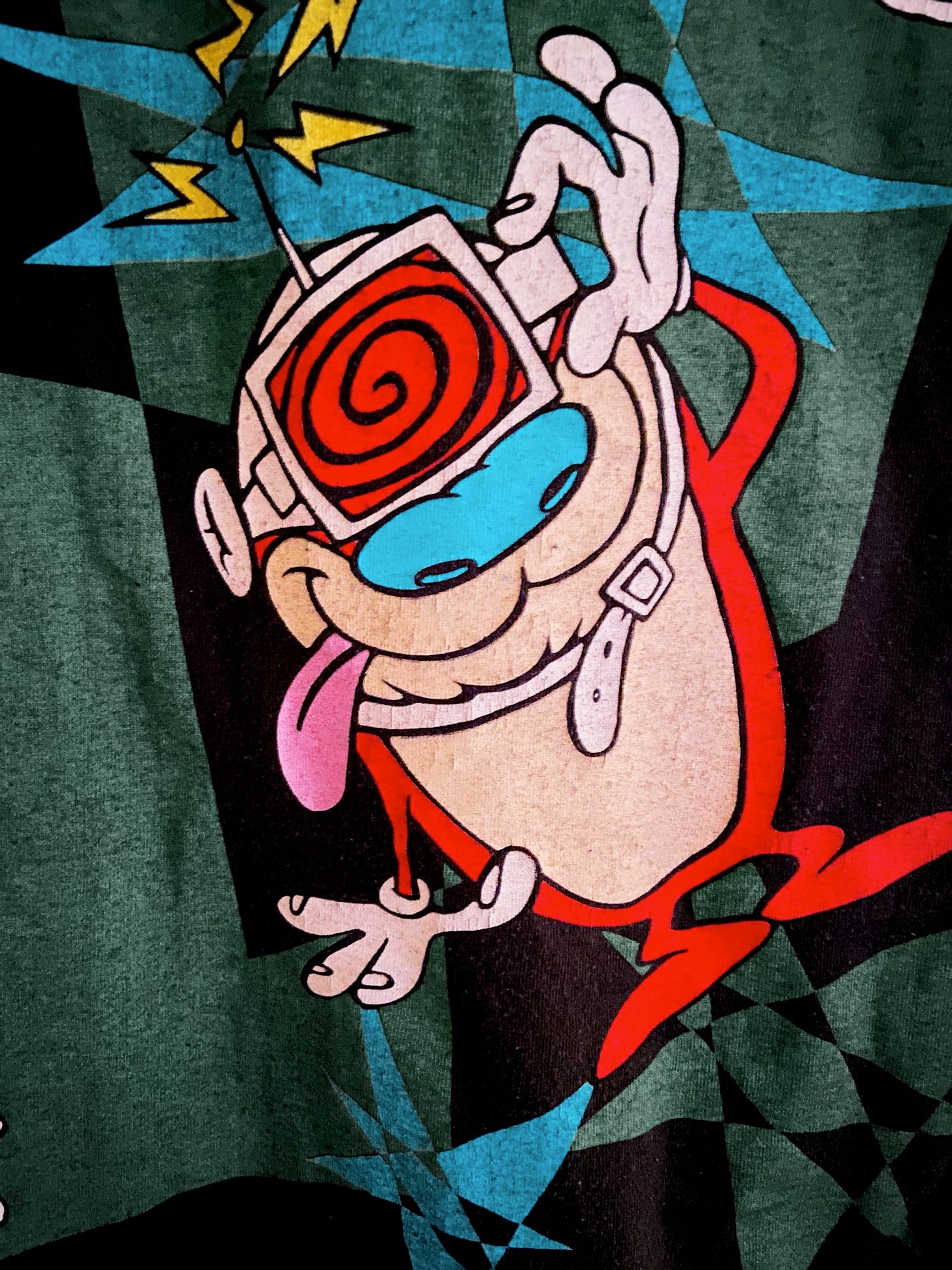 close up of Stimpy of Ren & Stimpy wearing swirly glasses in front of a 90s starburst motif.