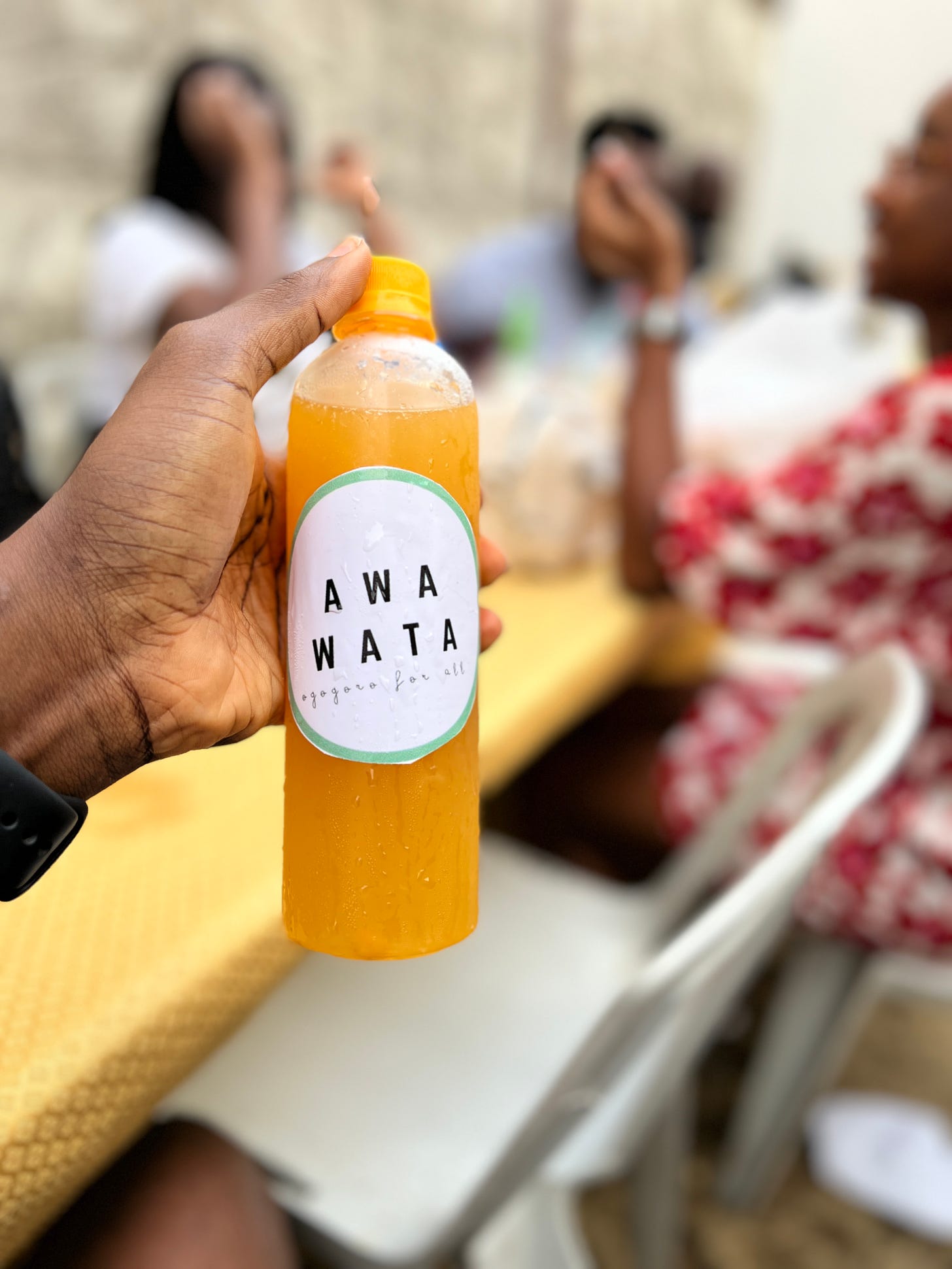 A picture of Awa Wata (our water) a citrus remix of the locally made alcoholic drink Ogogoro at a community get together at El Padrino in Lagos, Nigeria