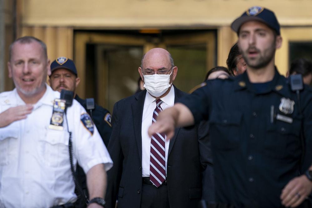 FILE - Law enforcement personnel escort the Trump Organization's former Chief Financial Officer Allen Weisselberg, center, as he departs court, Friday, Aug. 12, 2022, in New York. Former President Donald Trump’s longtime finance chief is expected to plead guilty as soon as Thursday, Aug. 18 in a tax evasion case that is the only criminal prosecution to arise from a long-running investigation into the former president’s company, three people familiar with the matter told The Associated Press. (AP Photo/John Minchillo, File)