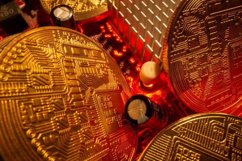 Representations of the virtual currency stand on a motherboard in this picture illustration taken May 20, 2021. REUTERS/Dado Ruvic/Illustration