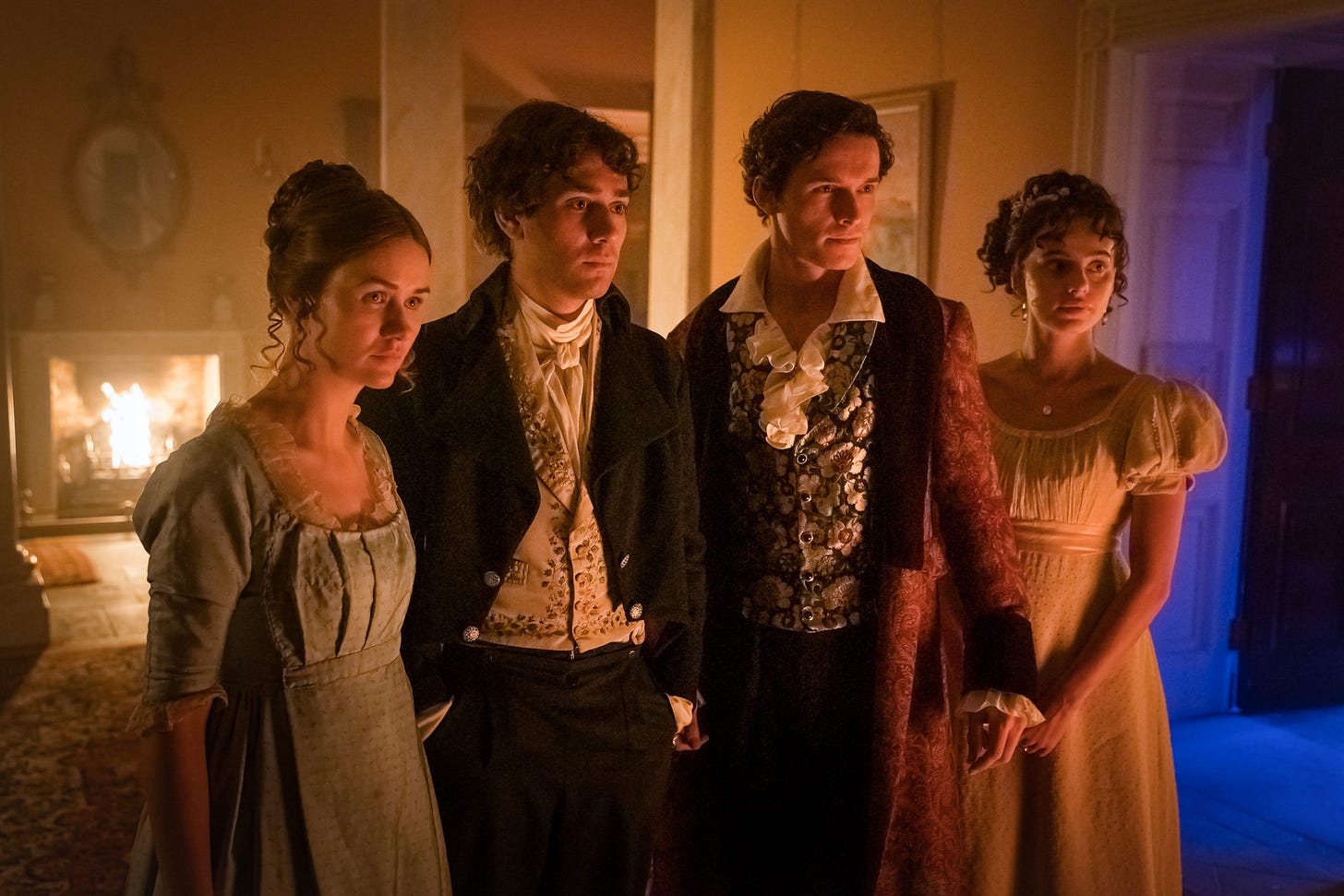 This image shows--from left to right--Mary Wollstonecraft Godwin (played by Lili Miller); Dr. John Polidori (played by Maxim Baldry); George Gordon, Lord Byron (played by Jacob Collins-Levy); and Claire Clairmont (played by Nadia Parkes) as they stand in a well-appointed room inside Villa Diodati. All four look off-camera at something that concerns them. This image shows--from left to right--Mary Wollstonecraft Godwin (played by Lili Miller); Dr. John Polidori (played by Maxim Baldry); George Gordon, Lord Byron (played by Jacob Collins-Levy); and Claire Clairmont (played by Nadia Parkes) as they stand in a well-appointed room inside Villa Diodati. All four look off-camera at something that concerns them.