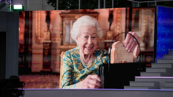 Queen Elizabeth II shows off a marmalade sandwich in a video with Paddington Bear shown during the Platinum Party At The Palace at Buckingham Palace on June 4.