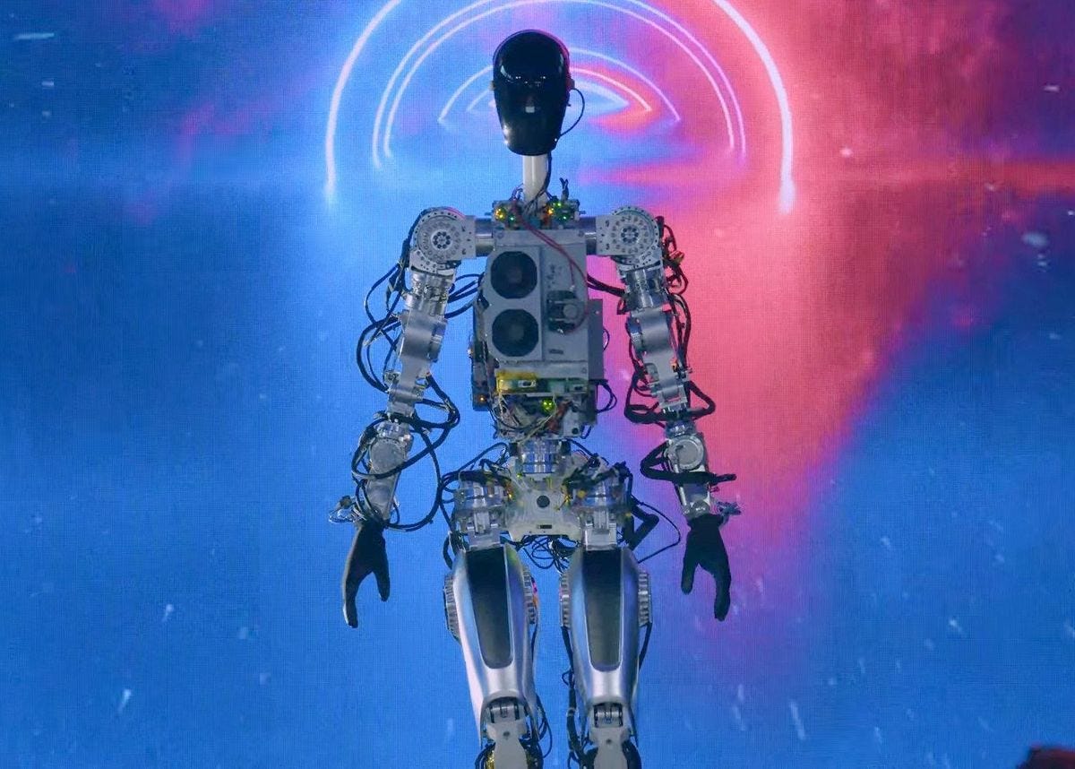 A humanoid robot with metal and wires exposed stands on stage.