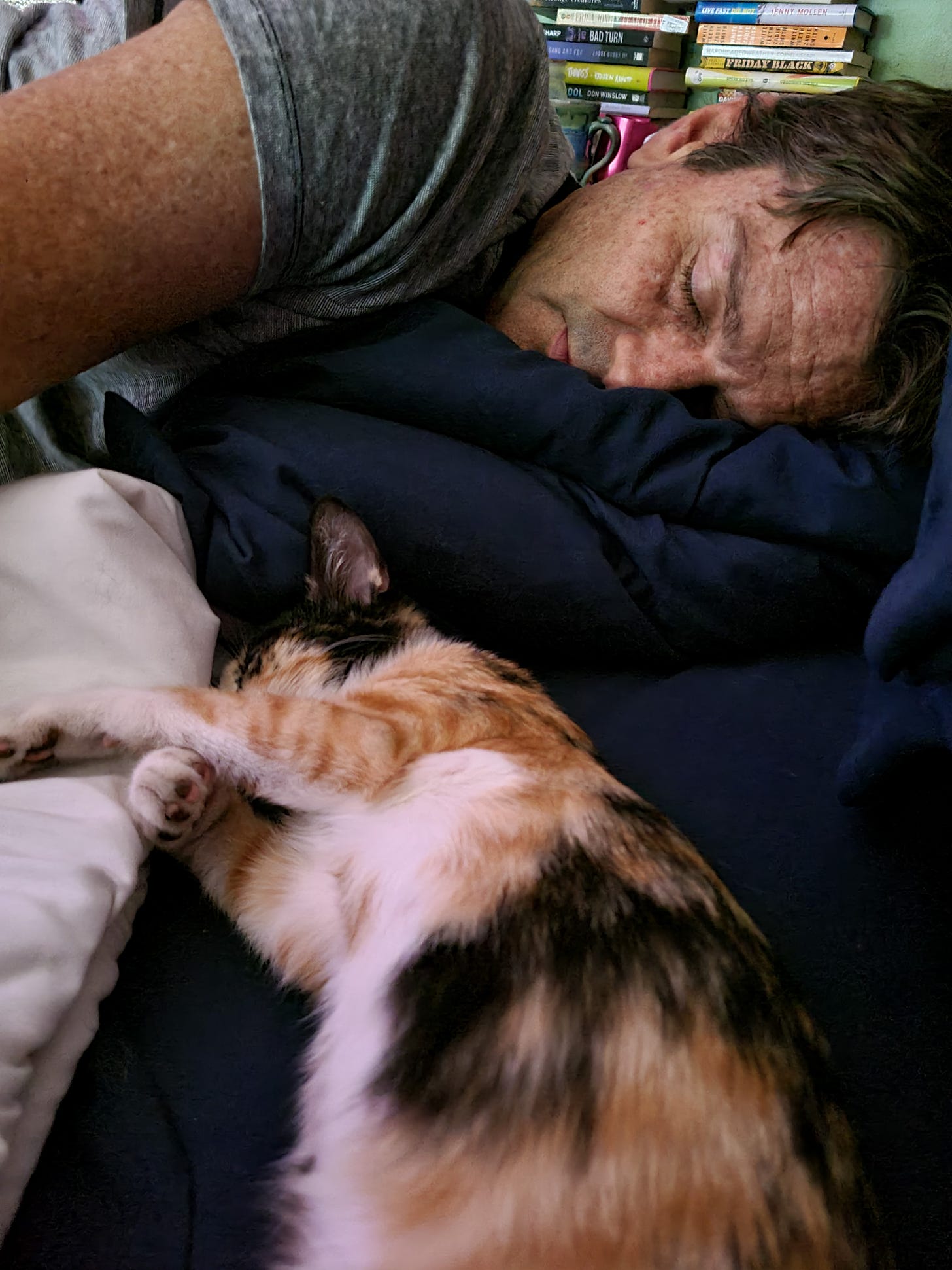 Man and kitten sleeping.