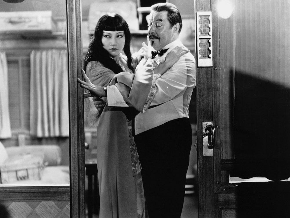 actors Anna May Wong and Warner Oland tangled in the doorway to a train compartment in the film Shanghai Express (1932)