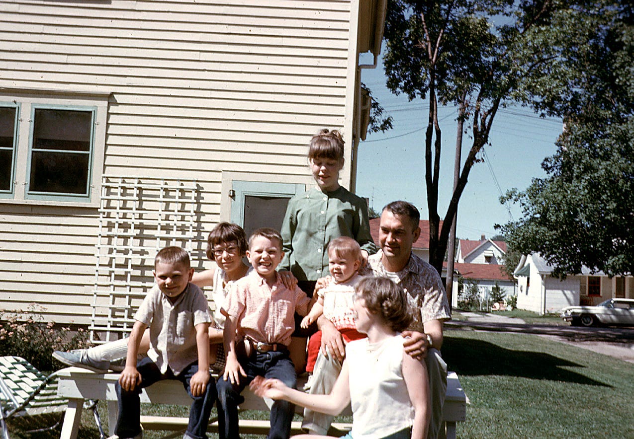 A group of people standing in front of a building

Description automatically generated