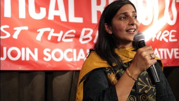 Seattle City Councilwoman Kshama Sawant in front of a Socialist Alternative banner