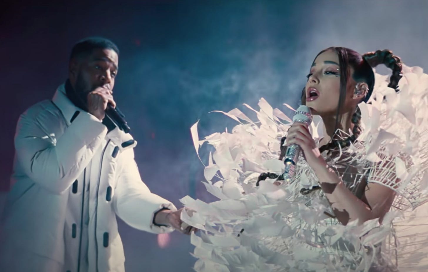 Movie still from Don't Look Up. Kid Cudi and Ariana Grande perform a concert together onstage.