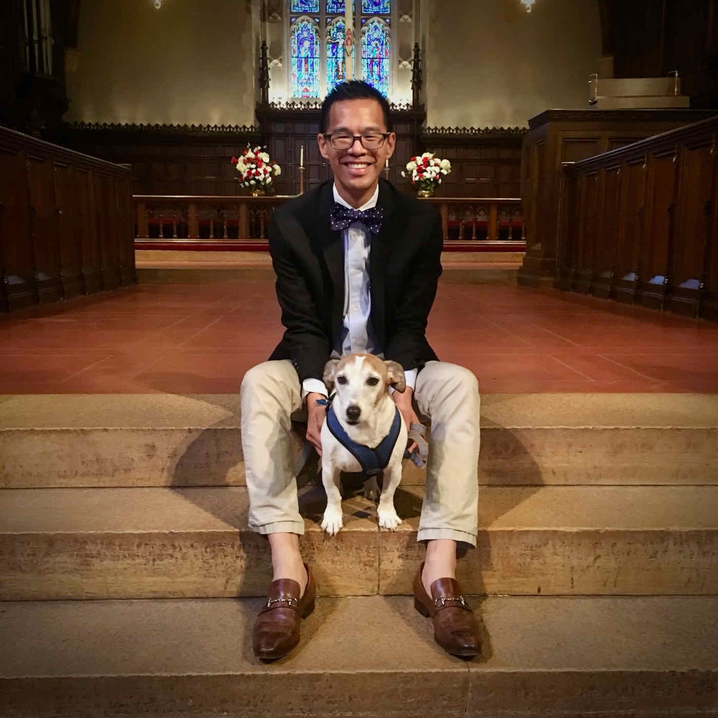 Jeff sitting on the chancel steps of the Reformed Church of Bronxville with a small Jack Russell terrier named Lincoln