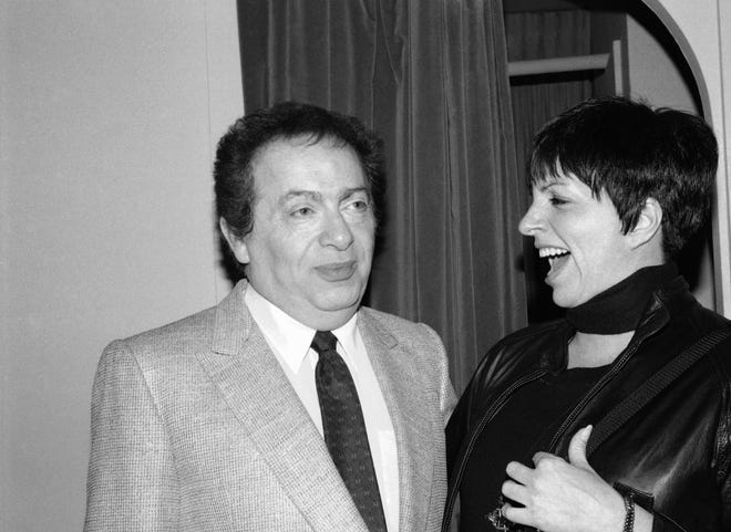 In this Feb. 4, 1991, file photo, Liza Minnelli chats with comic Jackie Mason during a visit backstage at the Neil Simon Theater in New York. Minnelli had dropped by to congratulate Mason on his new Broadway show, "Brand New."