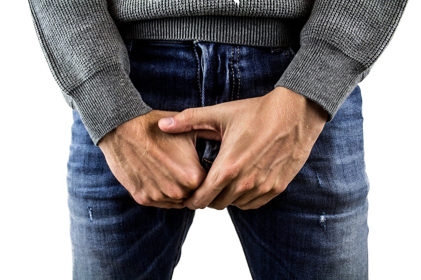 A man grabbing his crotch.