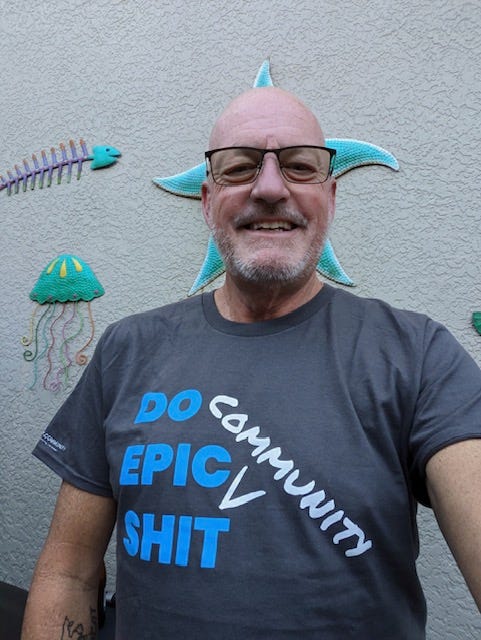 Tim wears shirt that says "Do Epic Community Shit" from Jenny.Community