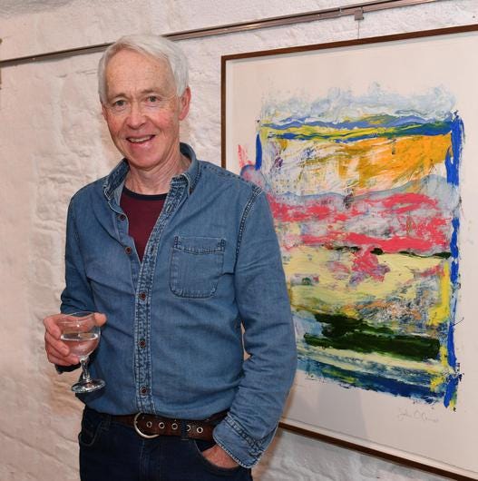 The late John O'Connor in front of one of his paintings at the North Louth Artists' 2022 exhibiton in The Basement Gallery